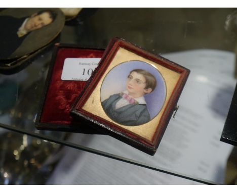 Late 19th century portrait miniature on ivory of a young boy, formally dressed in pink tie, contained in a fitted tooled leat