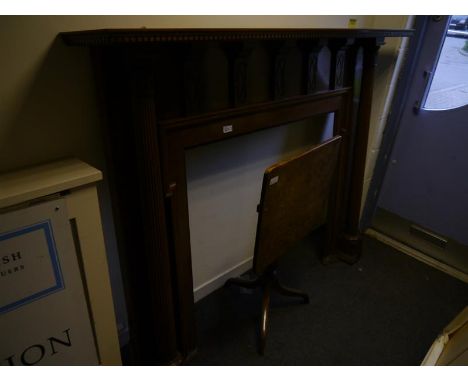 Large mahogany fire surround, early 20th century, with dentilled mantle shelf raised on fluted leaf carved columns. 1.47m by 
