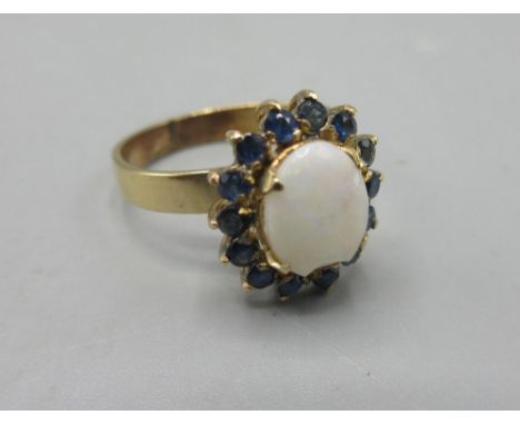 18ct yellow gold ring set with opal surrounded by sapphires, stamped 18k, N1/2, 3.2g