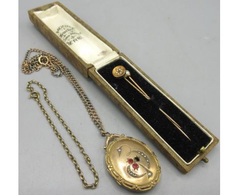 Victorian style locket set with red paste stones and seed pearls, stamped '9ct backs &amp; fronts' on a 9ct rose and white go