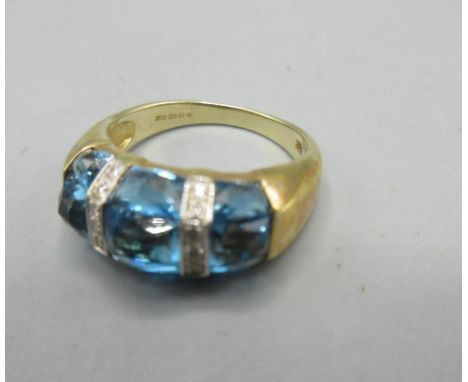 14ct yellow gold ring set with three blue stones separated by diamond set borders, stamped 585, size M1/2, 5.6g