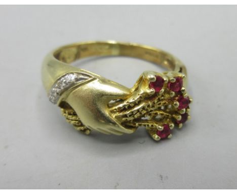 14ct yellow gold ring with hand and bouquet detail set with rubies and diamonds, stamped 14k, 4.9g