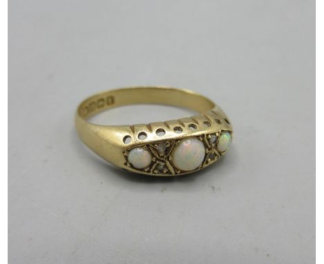 18ct yellow gold ring set with opals, stamped 18, 2.9g