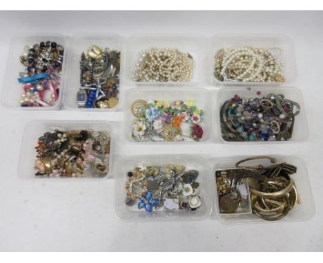 Large collection of vintage and modern costume jewellery including floral brooches and faux pearls