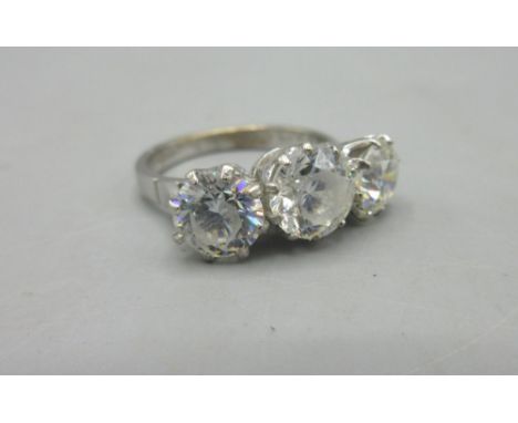 18ct white gold ring set with three clear stones, stamped 18, size N1/2, 5.6g