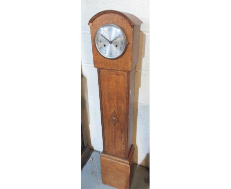 British Made oak granddaughter clock, 5 1/2" silvered Arabic dial, two train striking movement on a gong, H125cm