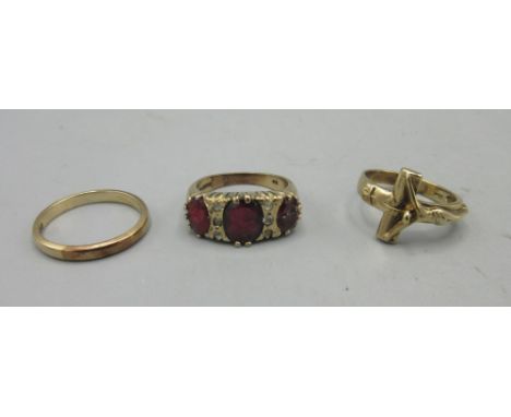 9ct yellow gold ring set with red and white stones, stamped 375, size O, a 9ct yellow gold band ring, size N1/2, 7.4g, and a 