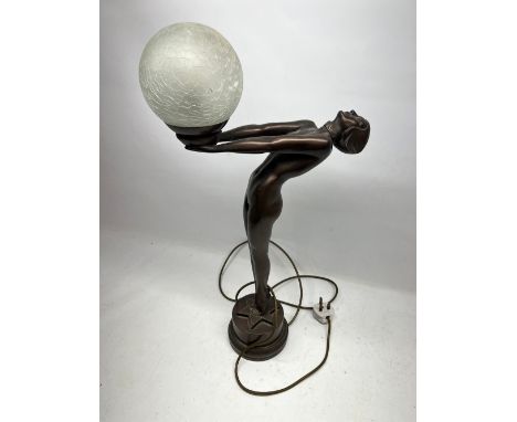 Art Deco style lamp in the shape of a female holding a spherical glass shade, H56.5cm