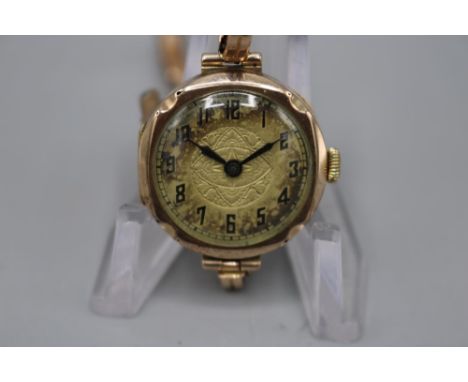 Swiss ladies 9ct gold wristwatch on 9ct gold expanding bracelet stamped 9ct, engraved silvered dial with Arabic chapter ring,