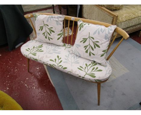 Ercol 2 seater.There are signs of restoration to the base of this piece.