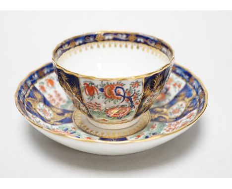 A Chamberlains Worcester good kakiemon style teabowl and saucer painted with oriental flowering plants in fan shaped panel, c