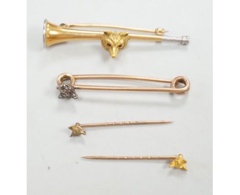 A Victorian yellow metal and diamond cluster set fox head pin, 44mm, two other fox head pins and a 15ct fox head and hunting 