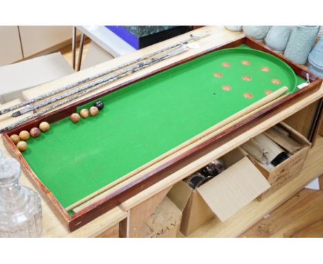 A bagatelle board, balls and cues, 108cm in length