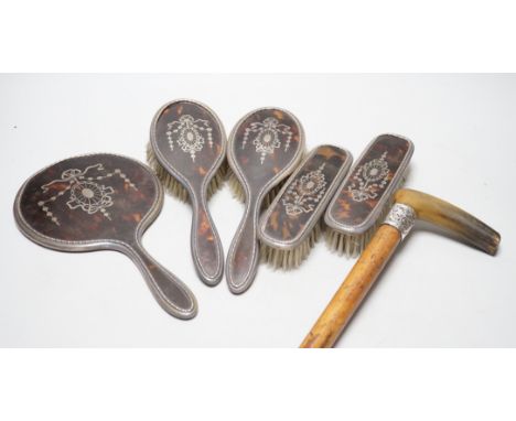 A George V silver and tortoiseshell five piece dressing table set and a silver mounted horn handled malacca walking stick.