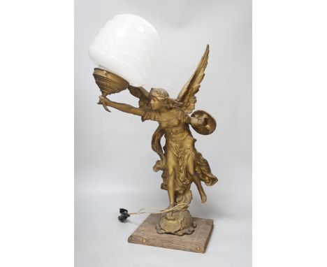 A gilt spelter Victory figural lamp with opaque glass shade, raised on a square base, 54cm high