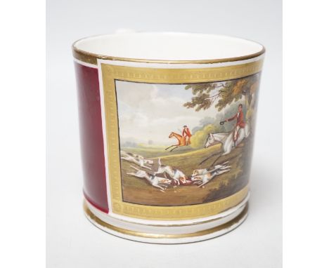 A 19th century English porcelain mug painted horses and riders with hunting dogs in a chase scene, the mug having a crimson g