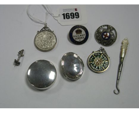 A Goldsmiths &amp; Silversmiths Hallmarked Silver Circular Pill Box, of plain design, on oval example with hinged lid, "Under