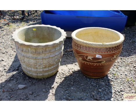 A concrete garden planter and a ceramic garden planter