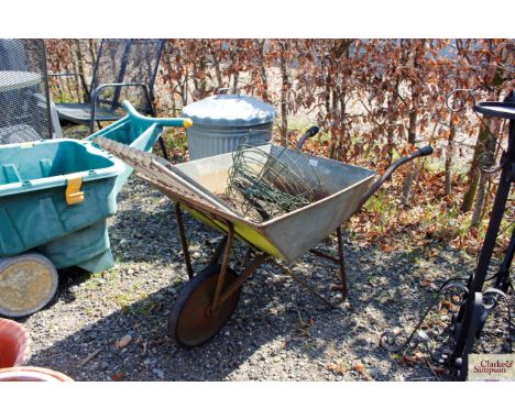 A light weight galvanised barrow containing two metal door mats; hanging baskets and brackets 