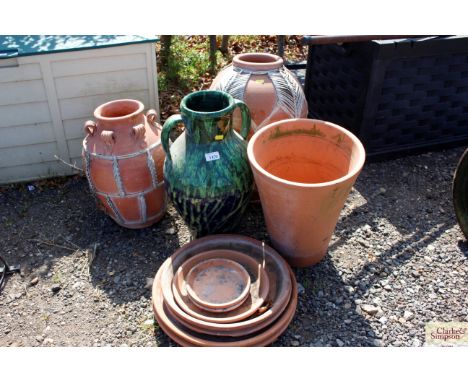 A terracotta plan pot; ceramic two handled pot and two urns etc