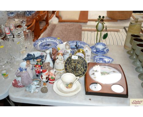 A quantity of decorative china to include Nao figurine; Anniversary clock; sundial; blue and white china etc