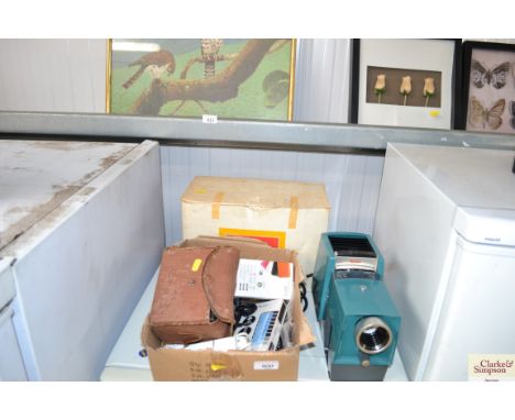 A box containing mobile phones, a power bank, Kodak projector, box camera etc. 