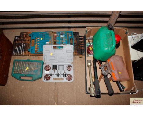 A boxed drill bit set and two other drill and screwdriver sets; a sanding set and a box containing long handled tools; petrol