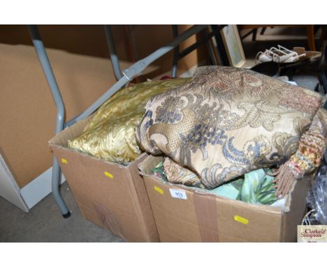 A box containing various materials; curtains; throws etc