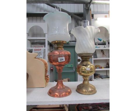A brass oil lamp and a copper oil lamp