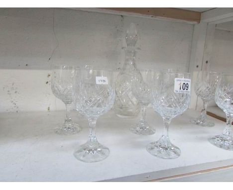 A glass decanter and 8 wine goblets