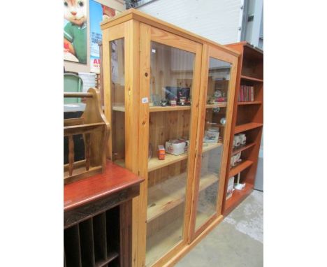 A pine 4 shelf glazed door bookcase