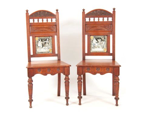 A PAIR OF EARLY 20TH CENTURY ARTS AND CRAFT OAK HALL CHAIRS of aesthetic design having ceramic panels to the backs.