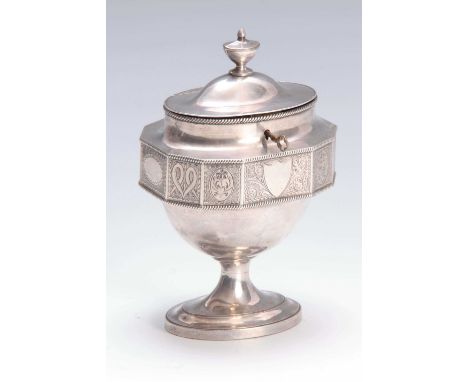 A LATE GEORGIAN SILVER PLATE OVAL PEDESTAL TEA CADDY the facetted body with gadrooned edges and engraved panel decoration ben