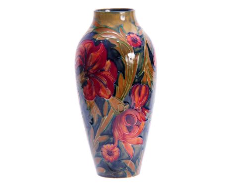 A WILLIAM MOORCROFT BURSLEM SPANISH PATTERN SLENDER TAPERING SHOULDERED VASE with all over tube lined decoration of swirled l