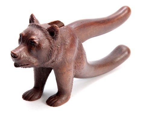 AN UNUSUAL LATE 19TH CENTURY SWISS BLACK FOREST NUTCRACKER formed as a standing bear 22cm overall.  