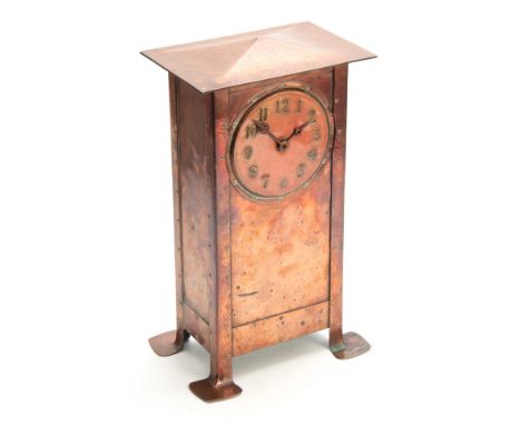 AN ARTS AND CRAFTS COPPER MANTEL CLOCK WITH RUSKIN DIAL in the manner of Richard Llewellyn Benson Rathbone, the hammered copp