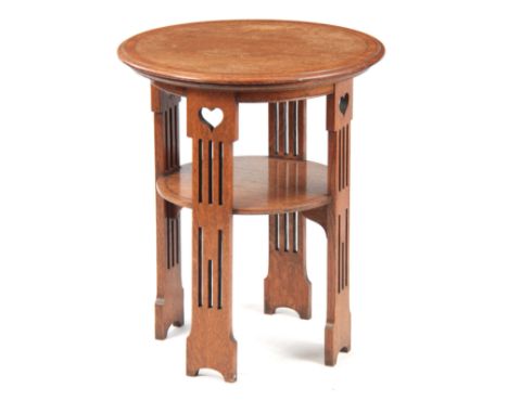 A LIBERTY STYLE ARTS AND CRAFTS OAK OCCASIONAL TABLE having a circular top with kingwood crossbanding and boxwood and ebony s