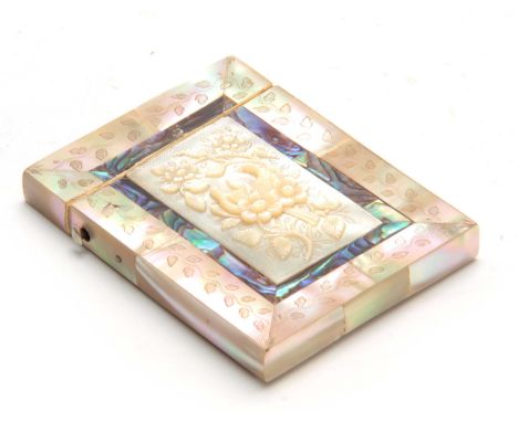 A 19TH CENTURY TWO-TONE MOTHER OF PEARL ENGRAVED CARD CASE with flower head carved relief panel to the front 10cm by 7.5cm