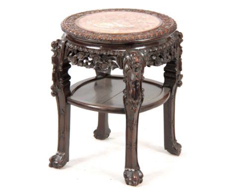 A 19th CENTURY PROFUSELY CARVED CHINESE HARDWOOD CIRCULAR JARDINIERE STAND with marble inset top and pierced floral work frie