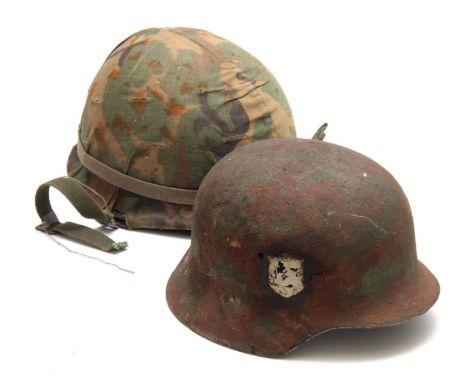 TWO SECOND WORLD WAR ARMY HELMETS,  the camouflage example American, the other German 