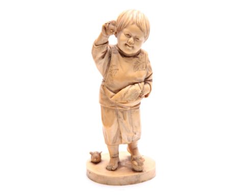 A JAPANESE MEIJI PERIOD CARVED IVORY OKIMONO OF A YOUNG BOY PLAYING WITH BIRDS signed with character marks underneath 23cm hi