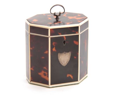 A GEORGE III TORTOISESHELL OCTAGONAL SHAPED TEA CADDY with ivory edges and shield-shaped plaque, with axe head handle to the 