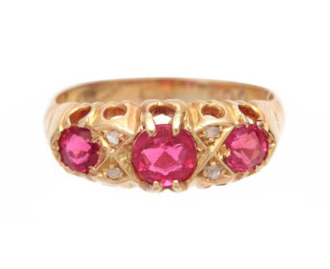 A 9CT GOLD AND RUBY SET RING having three ruby stones in claw settings hallmarked 9ct gold  