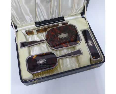 George VI silver mounted brush set comprising hairbrush, clothes brush, hand mirror and comb, in original fitted case, London
