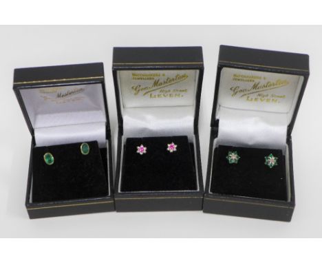 Pair of 9ct gold and emerald stud earrings, pair of diamond and emerald flowerhead earrings and a pair of ruby and diamond fl