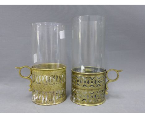 Pair of pierced brass storm candle sticks with glass storm light covers, 21cm (2) 