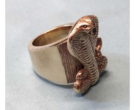 A large yellow metal ring with cobra motif, unmarked, size V, 61.7g, (tested as 9ct gold). 