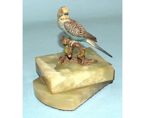 A cold-painted bronze figure of a budgerigar perched on a branch, 8.5cm high, mounted on a double onyx stand, 12cm high overa