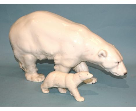 A large mid-20th century ceramic model of a polar bear, 46cm long, 27cm high, impressed 13365,29 and another, smaller polar b