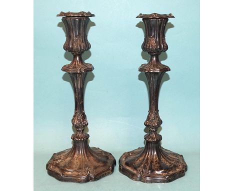 A pair of Victorian silver candlesticks by Henry Wilkinson &amp; Co, of fluted knopped baluster form, the columns with acanth
